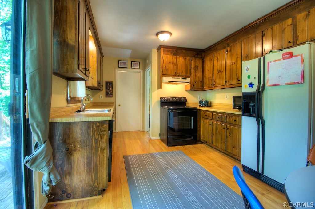 8430 Boones Trail Road Chesterfield, VA 23832 - Photo 8 of 24 a kitchen with stainless steel appliances granite countertop a refrigerator a sink dishwasher and wooden cabinets with wooden floor