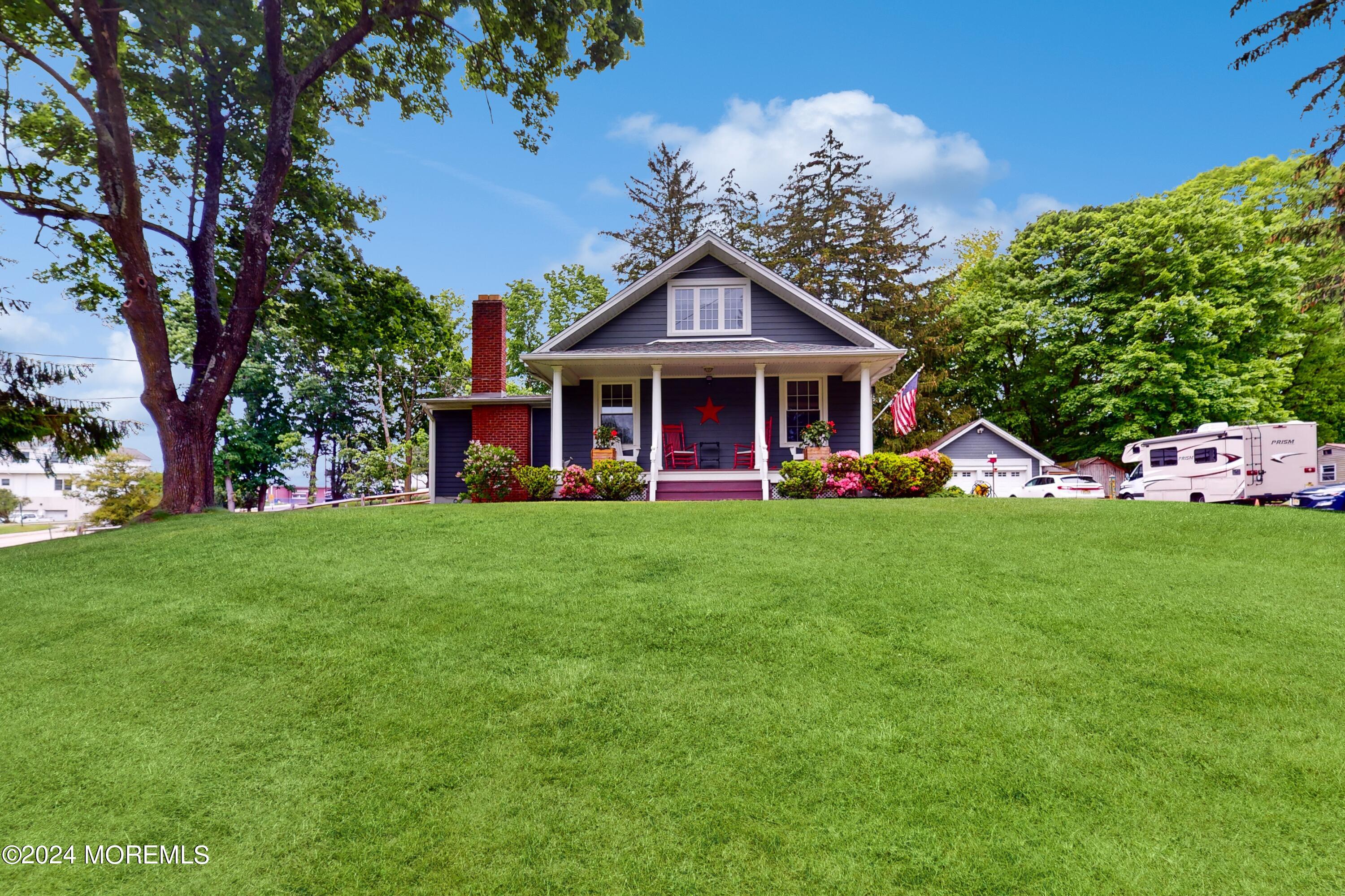 35 Nolan Road Morganville, NJ 07751 - Photo 1 of 1 a front view of a house with a yard table and chairs