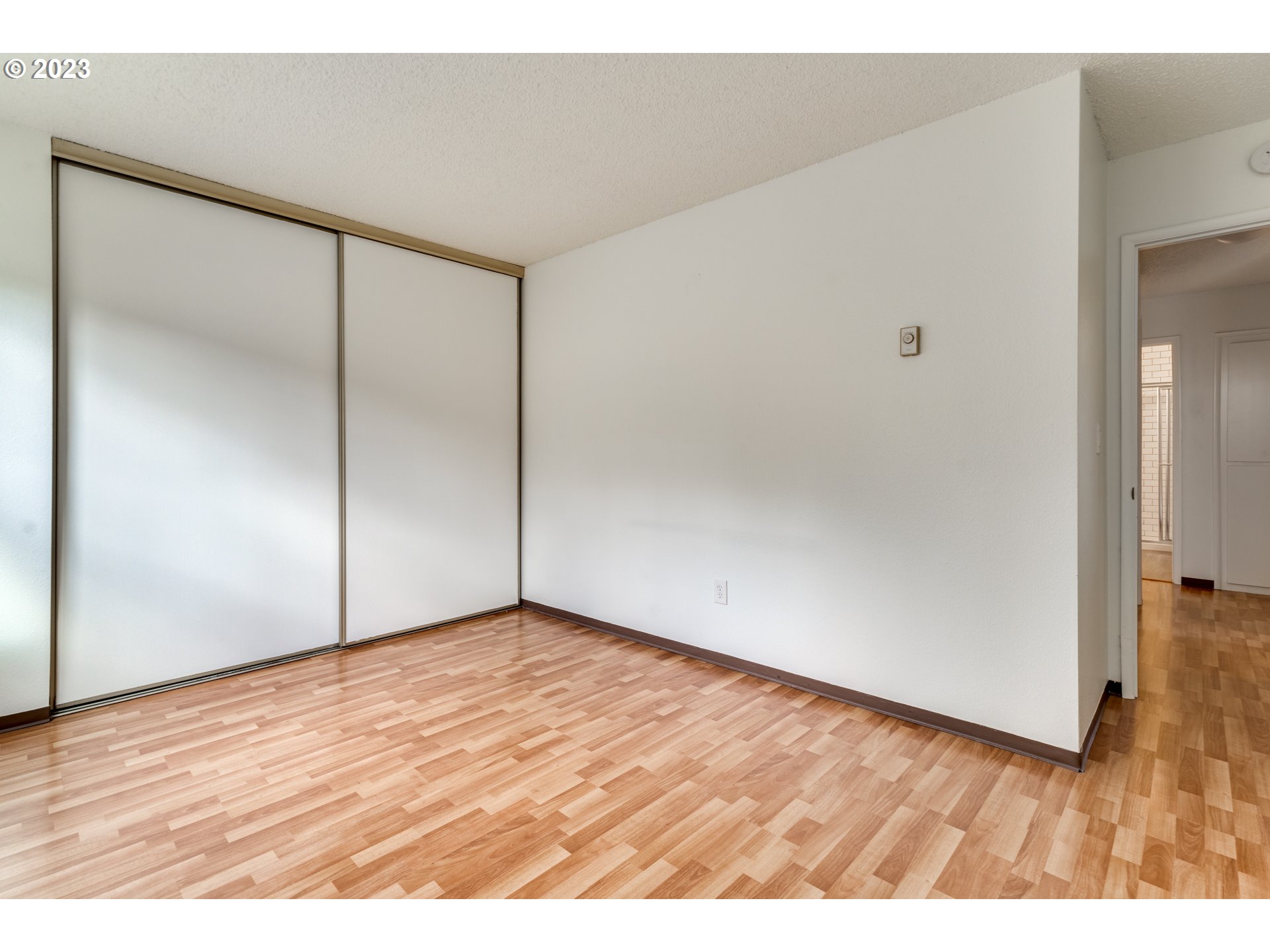 8421 Southwest 30th Avenue Portland, OR 97219 - Photo 12 of 28 a view of an empty room with wooden floor
