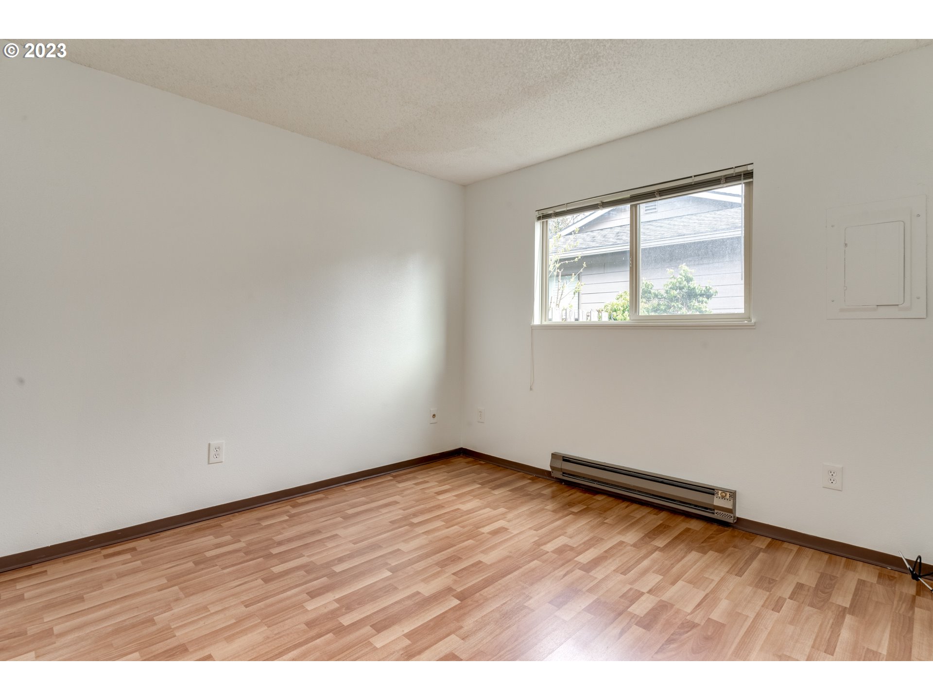 8421 Southwest 30th Avenue Portland, OR 97219 - Photo 19 of 28 an empty room with wooden floor and windows