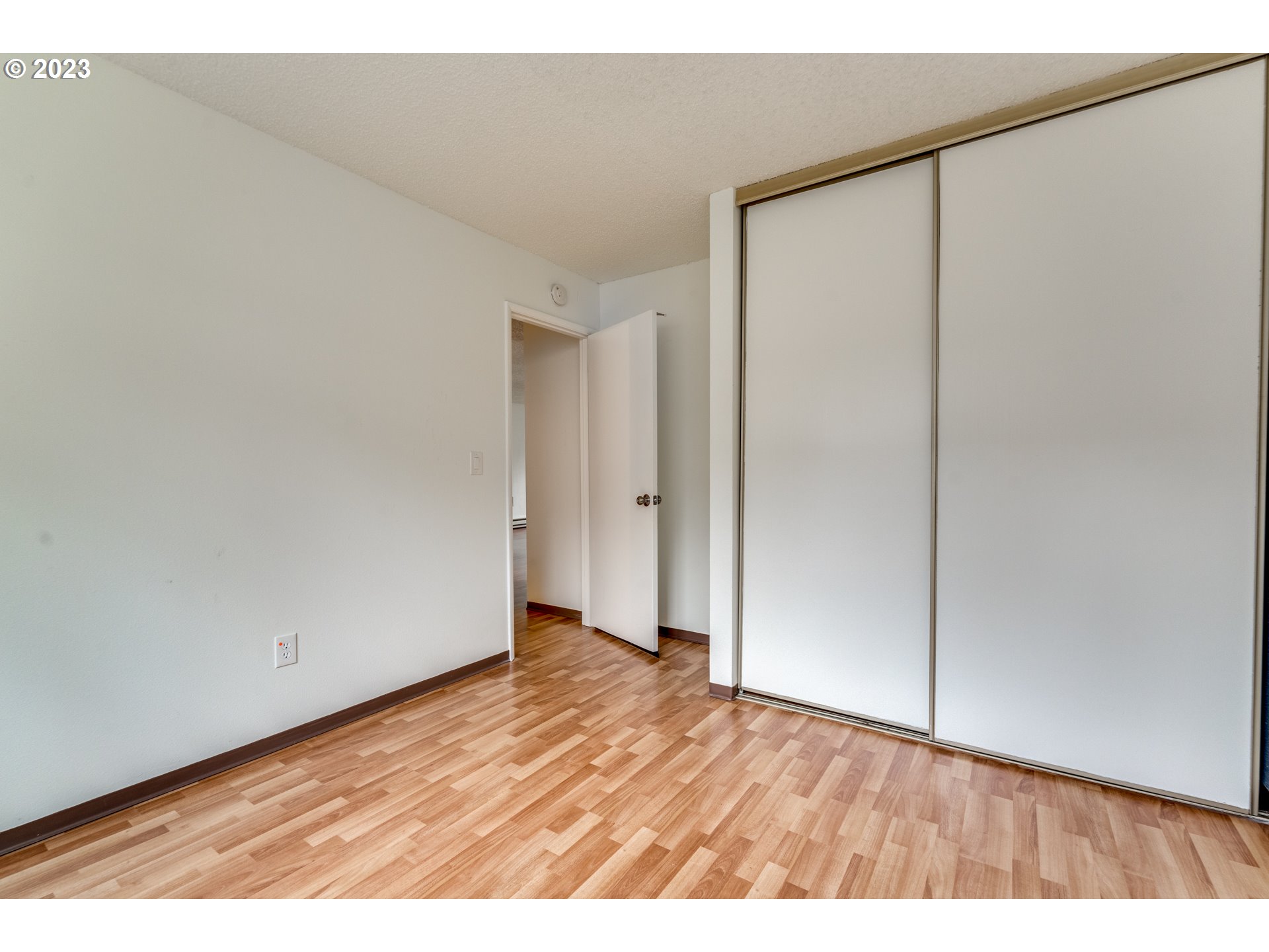 8421 Southwest 30th Avenue Portland, OR 97219 - Photo 20 of 28 a view of an empty room with wooden floor