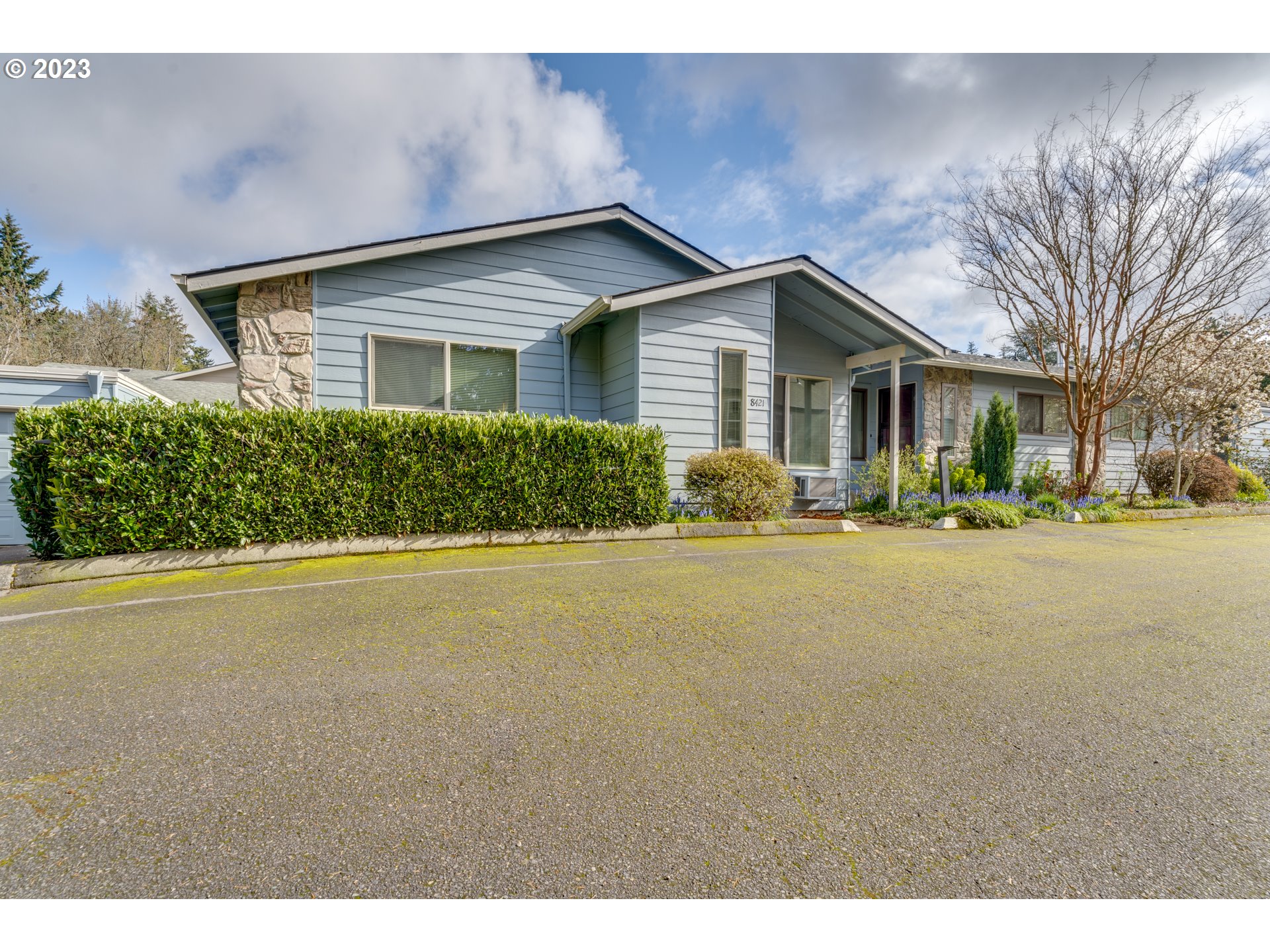 8421 Southwest 30th Avenue Portland, OR 97219 - Photo 2 of 28 a front view of a house with a yard and garage