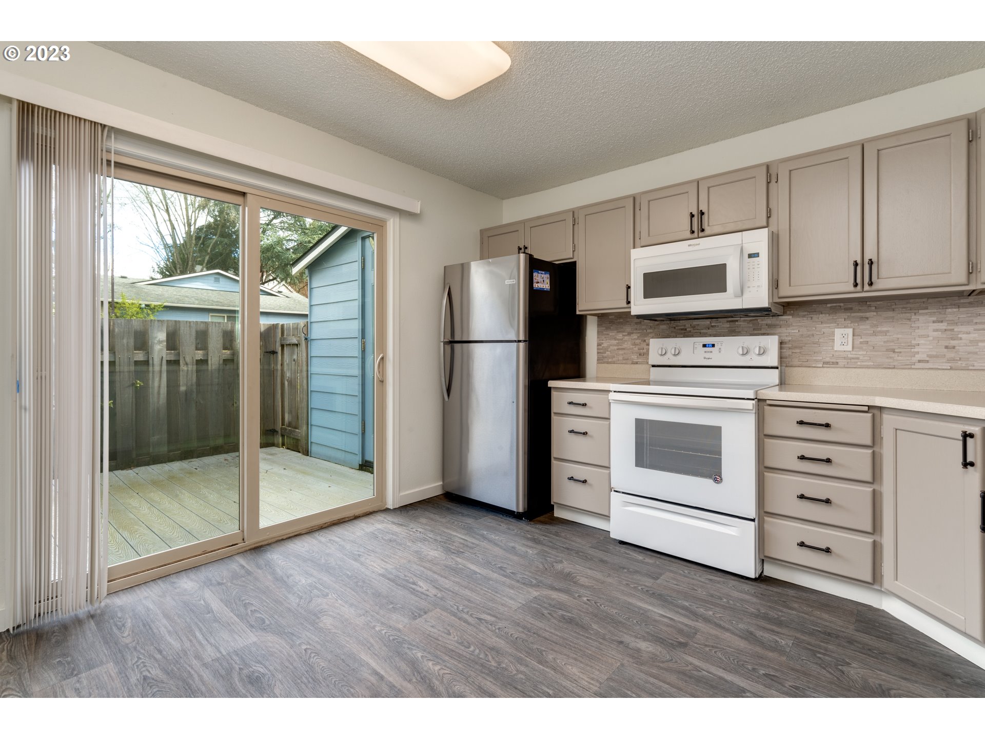 8421 Southwest 30th Avenue Portland, OR 97219 - Photo 5 of 28 a kitchen with stainless steel appliances a stove top oven and a refrigerator