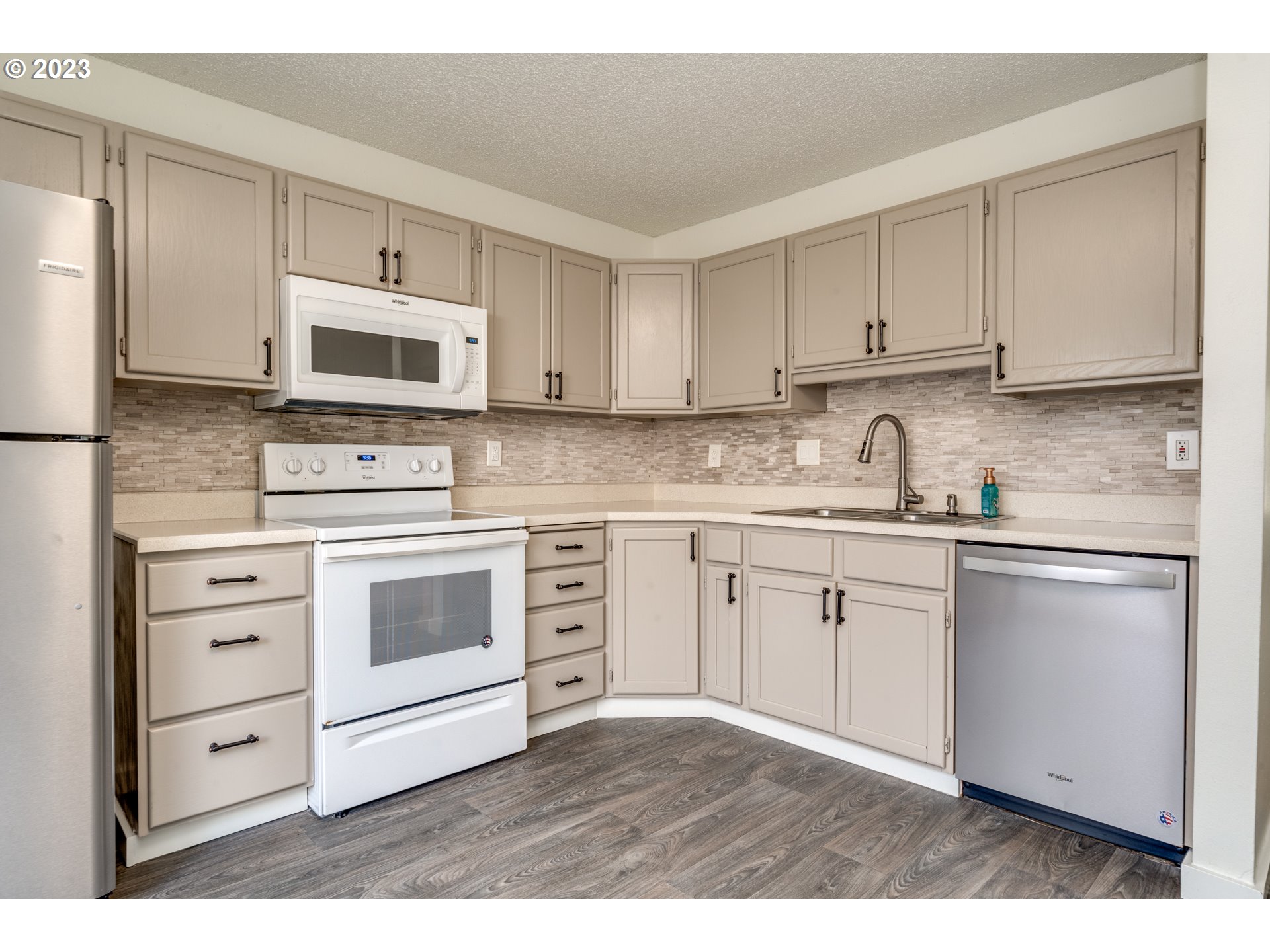 8421 Southwest 30th Avenue Portland, OR 97219 - Photo 6 of 28 a kitchen with cabinets stainless steel appliances and sink