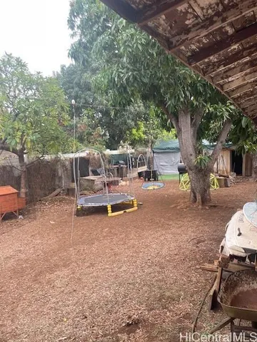a backyard of a house with table and chairs