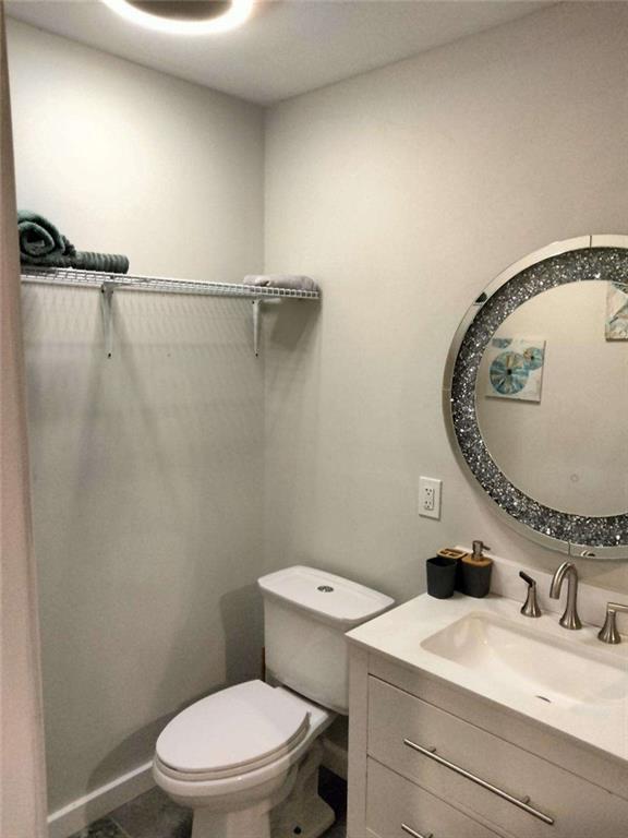 2130 Keheley Drive Decatur, GA 30032 - Photo 16 of 23 a bathroom with a granite countertop sink mirror vanity and toilet