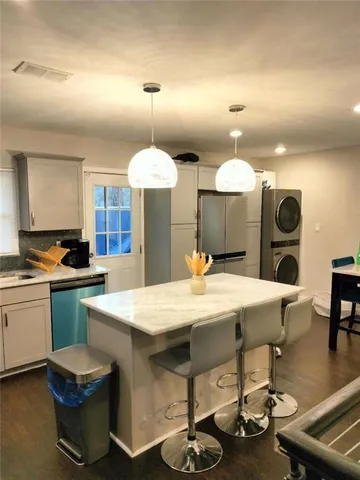 a stove top oven sitting inside of a kitchen