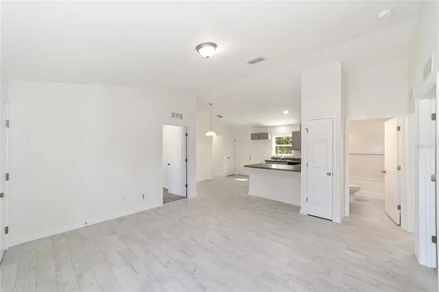 a view of a kitchen with a sink and refrigerator