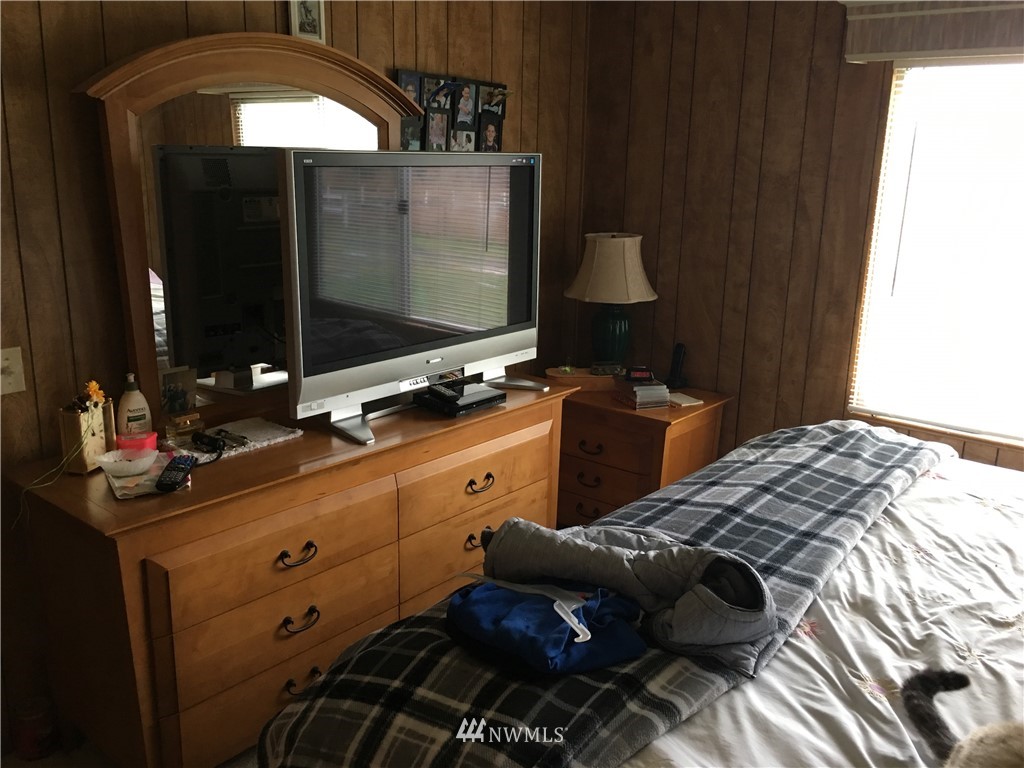 312 Meier Road Winlock, WA 98596 - Photo 12 of 18 a bedroom with a bed and a flat tv screen on dresser