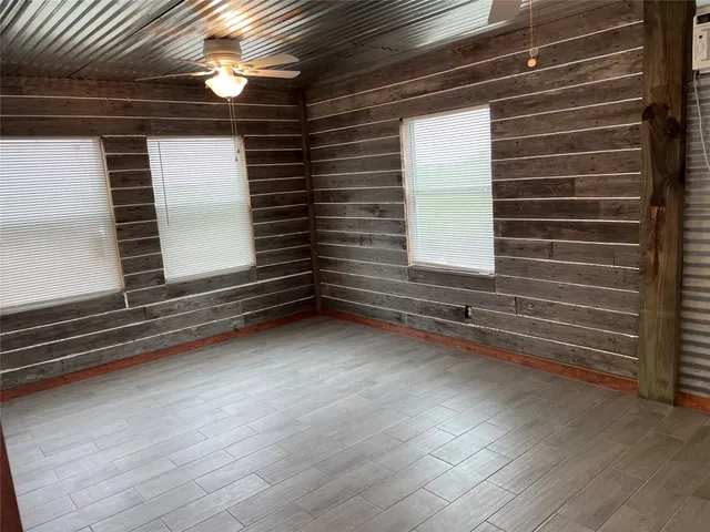 a view of room with window and wooden floor