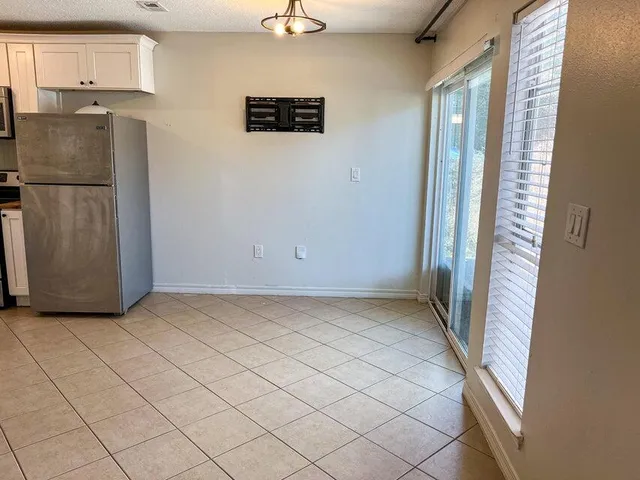an empty room with wooden floor and a window