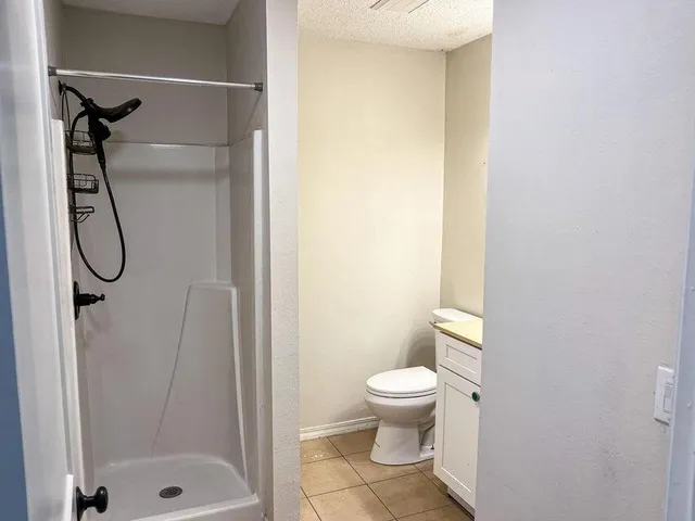 a bathroom with a toilet a sink and a mirror