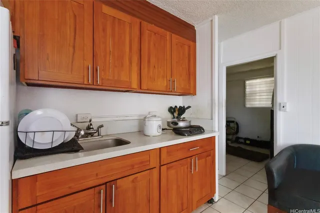 a kitchen with stainless steel appliances granite countertop a sink dishwasher stove and cabinets