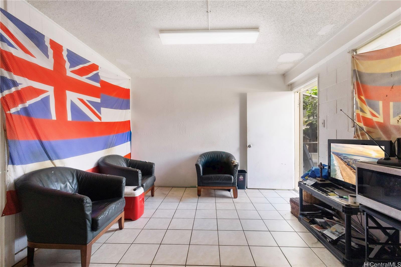 219 Kalihi Street Honolulu, HI 96819 - Photo 12 of 25 a living room with furniture and a fireplace