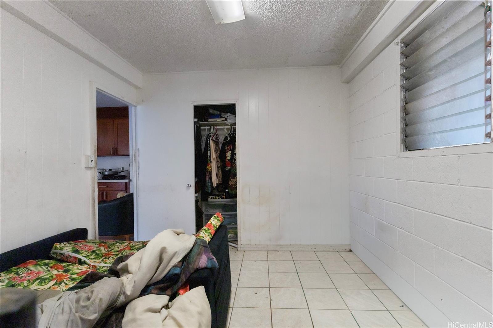 219 Kalihi Street Honolulu, HI 96819 - Photo 16 of 25 a bedroom with a bed and a window