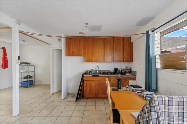 a room with stainless steel appliances granite countertop a refrigerator and a sink