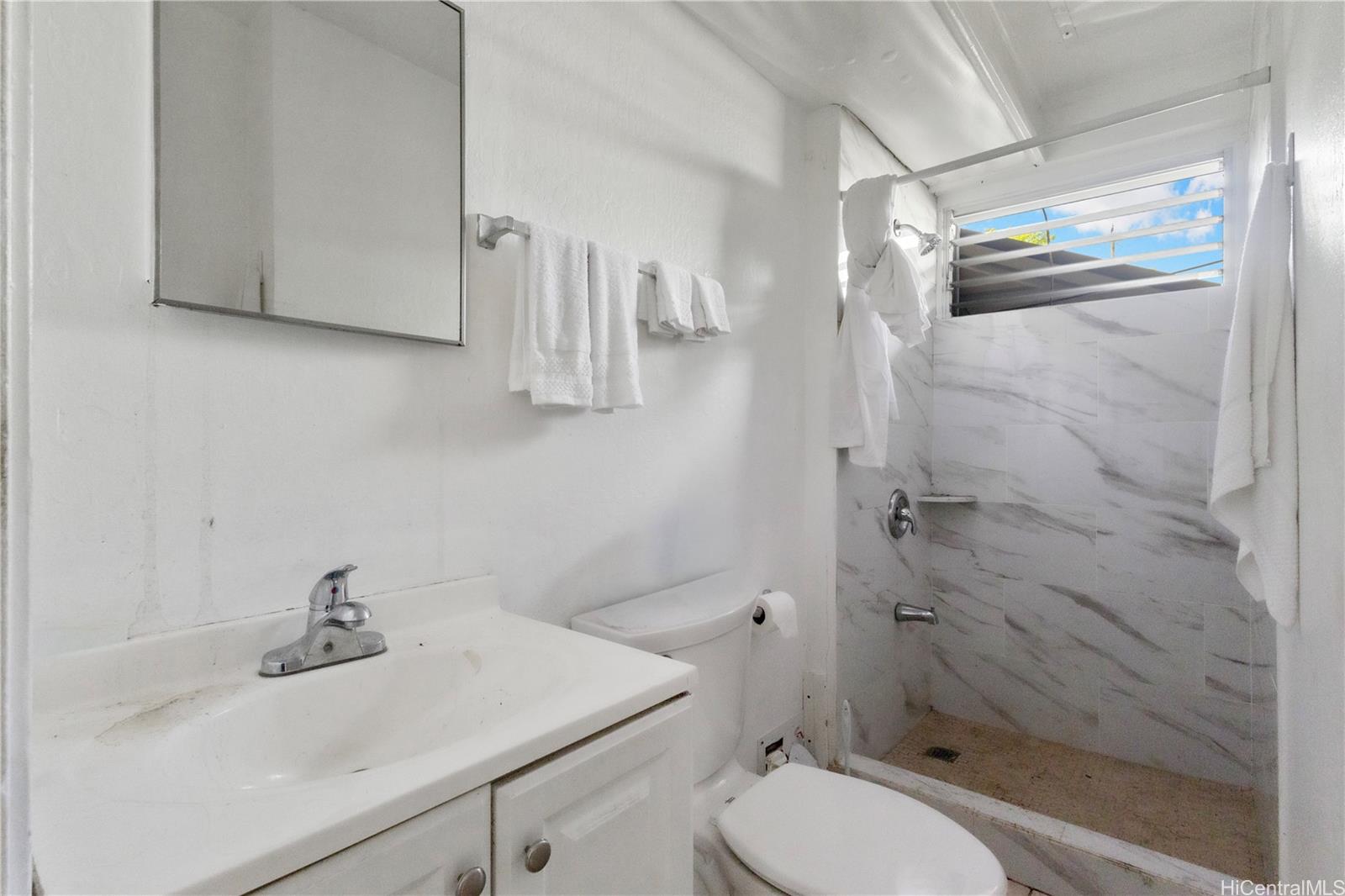 219 Kalihi Street Honolulu, HI 96819 - Photo 9 of 25 a bathroom with a sink a toilet and shower