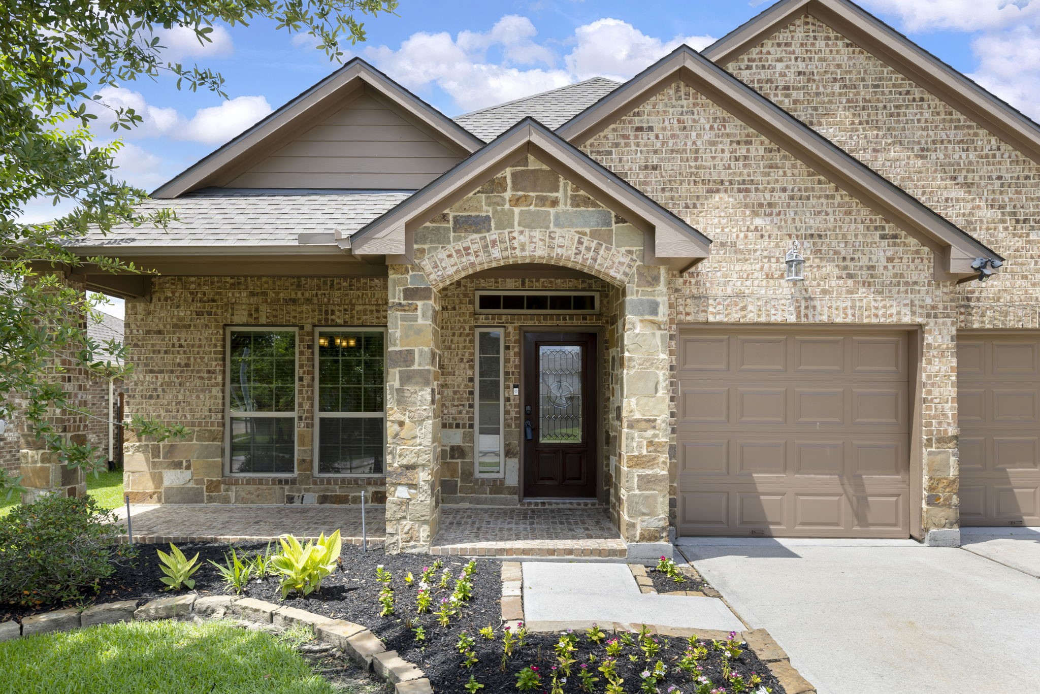 23911 Augusta Falls Lane Spring, TX 77389 - Photo 2 of 40 a front view of a house with garden
