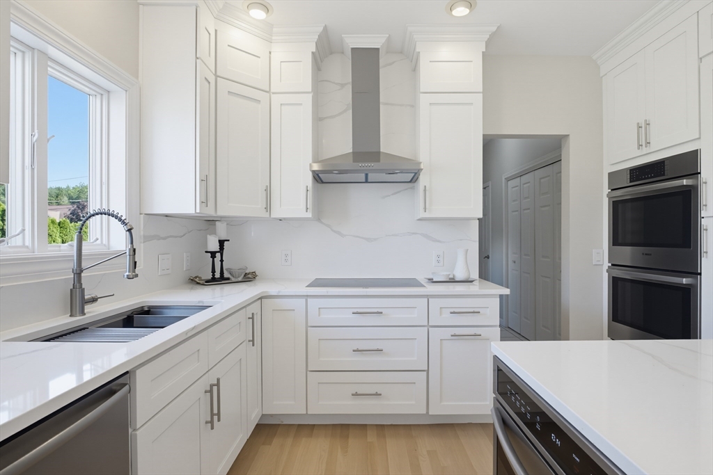 226 Olympic Road Somerset, MA 02726 - Photo 5 of 42 a kitchen with a sink stove and refrigerator