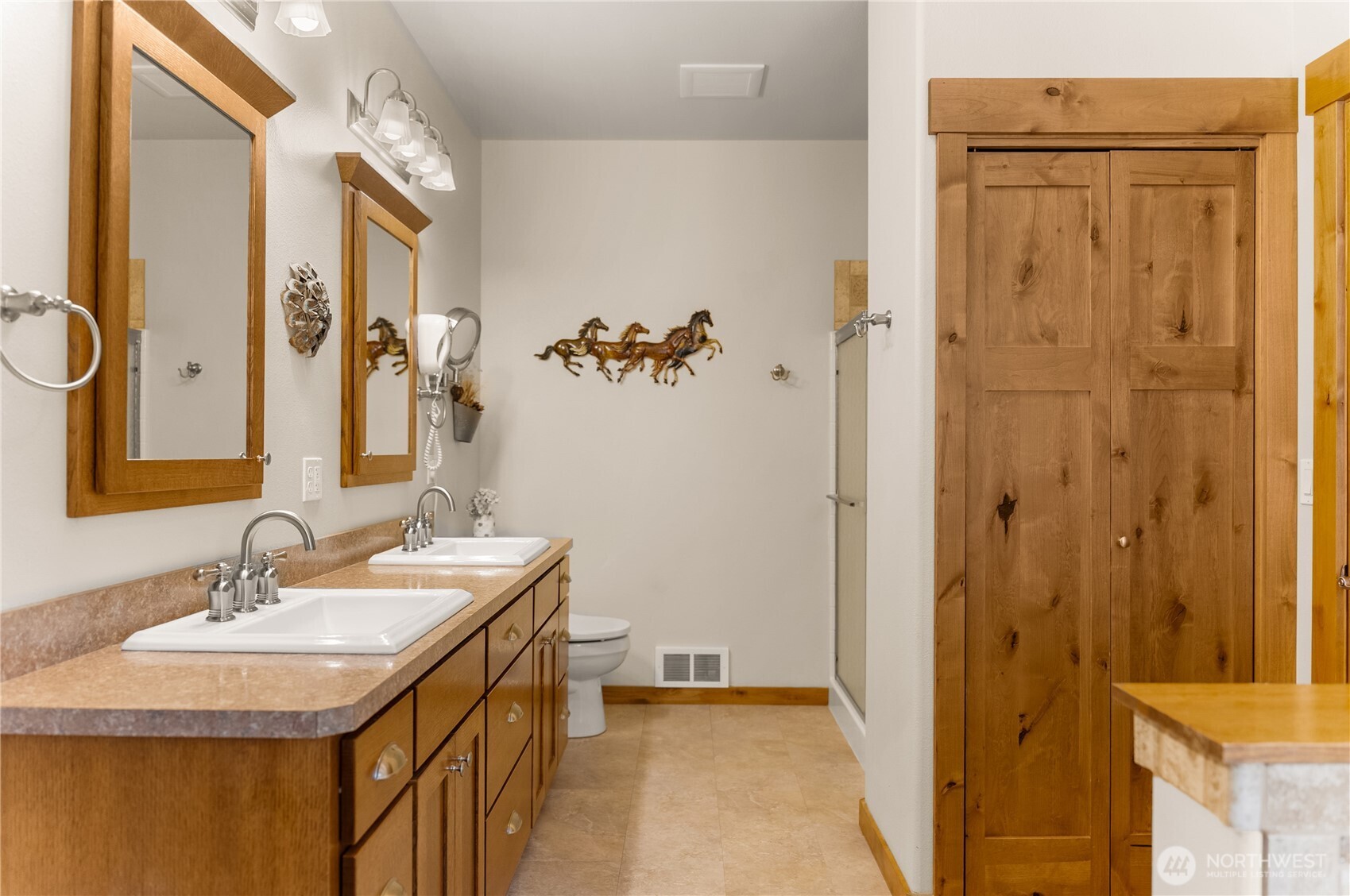 23 George Road Omak, WA 98841 - Photo 20 of 40 a bathroom with a sink a mirror and a shower