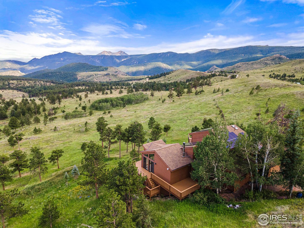 134 Old Post Office Road Boulder, CO 80302 - Photo 3 of 40 a view of a lush green hillside and a houses