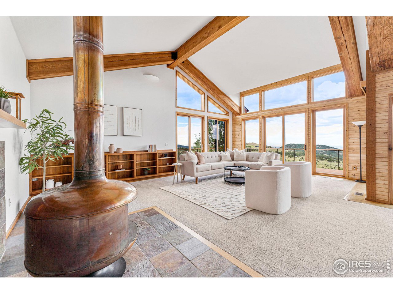 134 Old Post Office Road Boulder, CO 80302 - Photo 6 of 40 a living room with furniture a fireplace and a large window