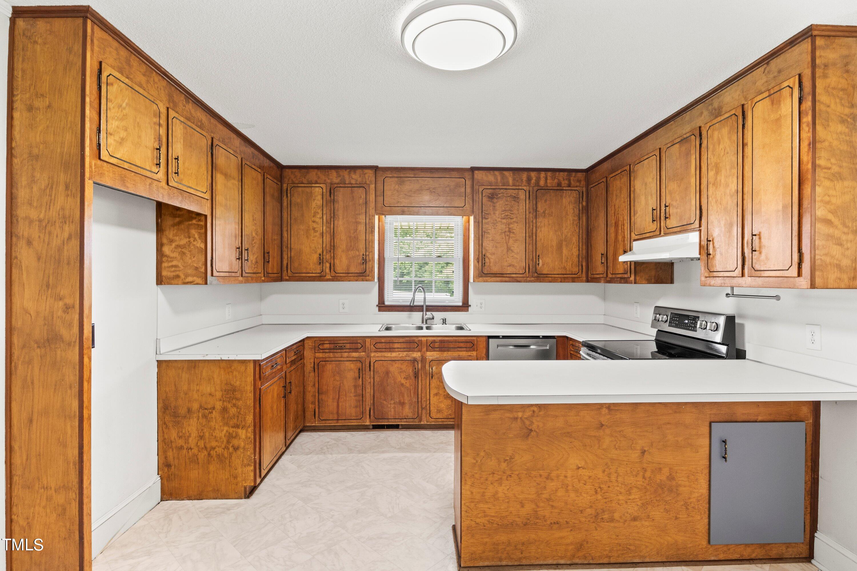 11 Partin Road Dunn, NC 28334 - Photo 12 of 46 a kitchen with stainless steel appliances granite countertop a sink a stove and a refrigerator