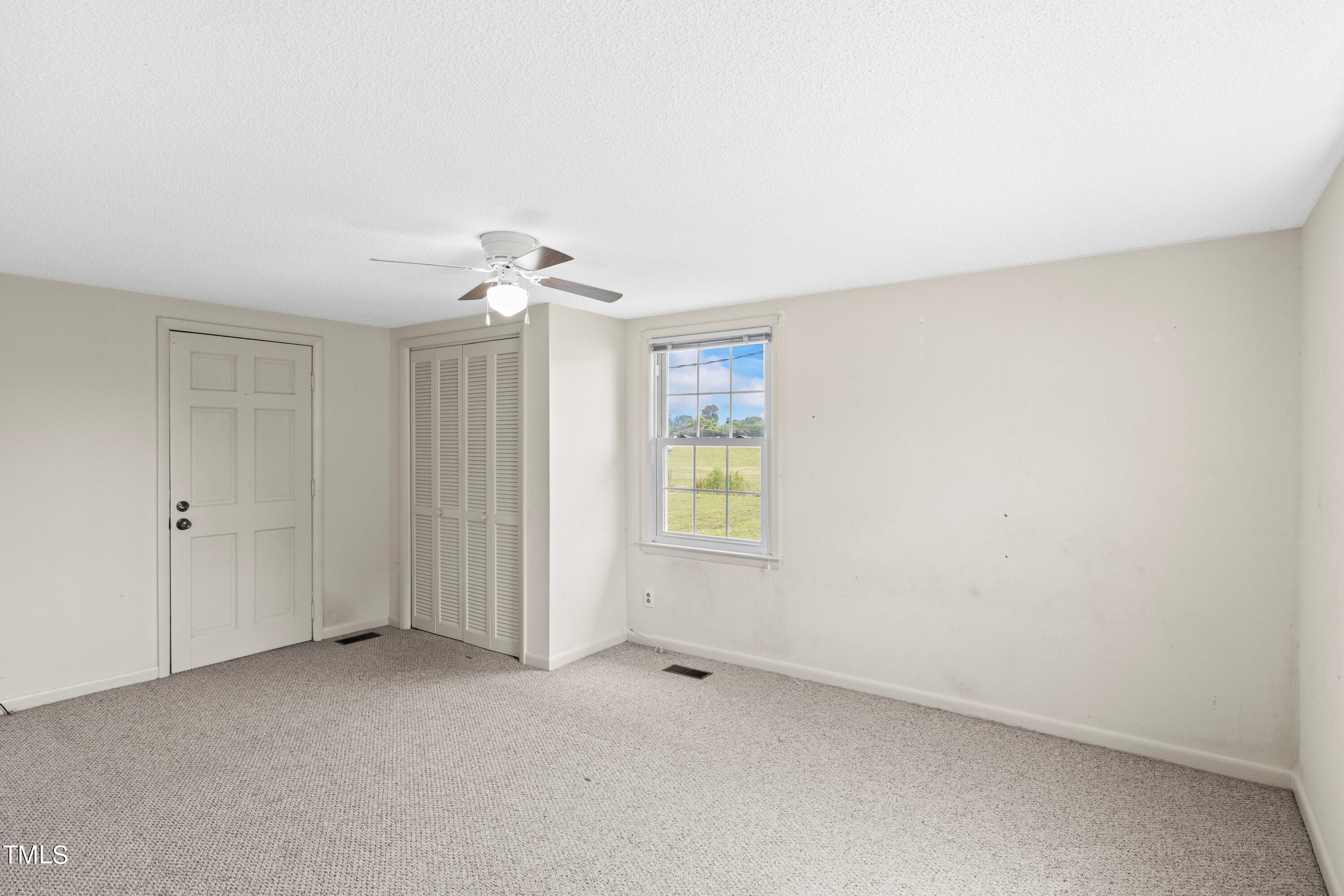 11 Partin Road Dunn, NC 28334 - Photo 20 of 46 an empty room with a ceiling fan and window