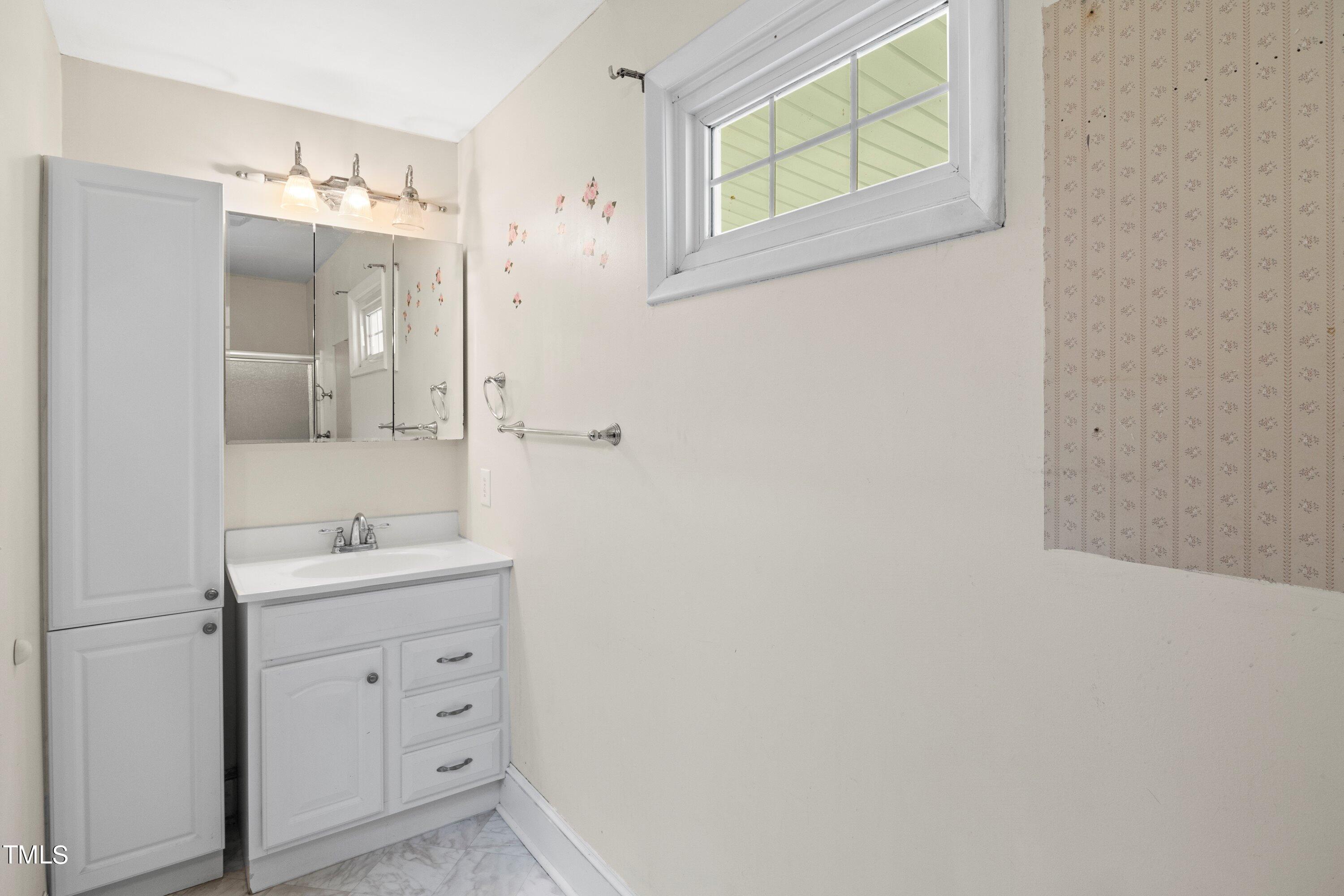 11 Partin Road Dunn, NC 28334 - Photo 23 of 46 a bathroom with a sink a light fixture and a mirror