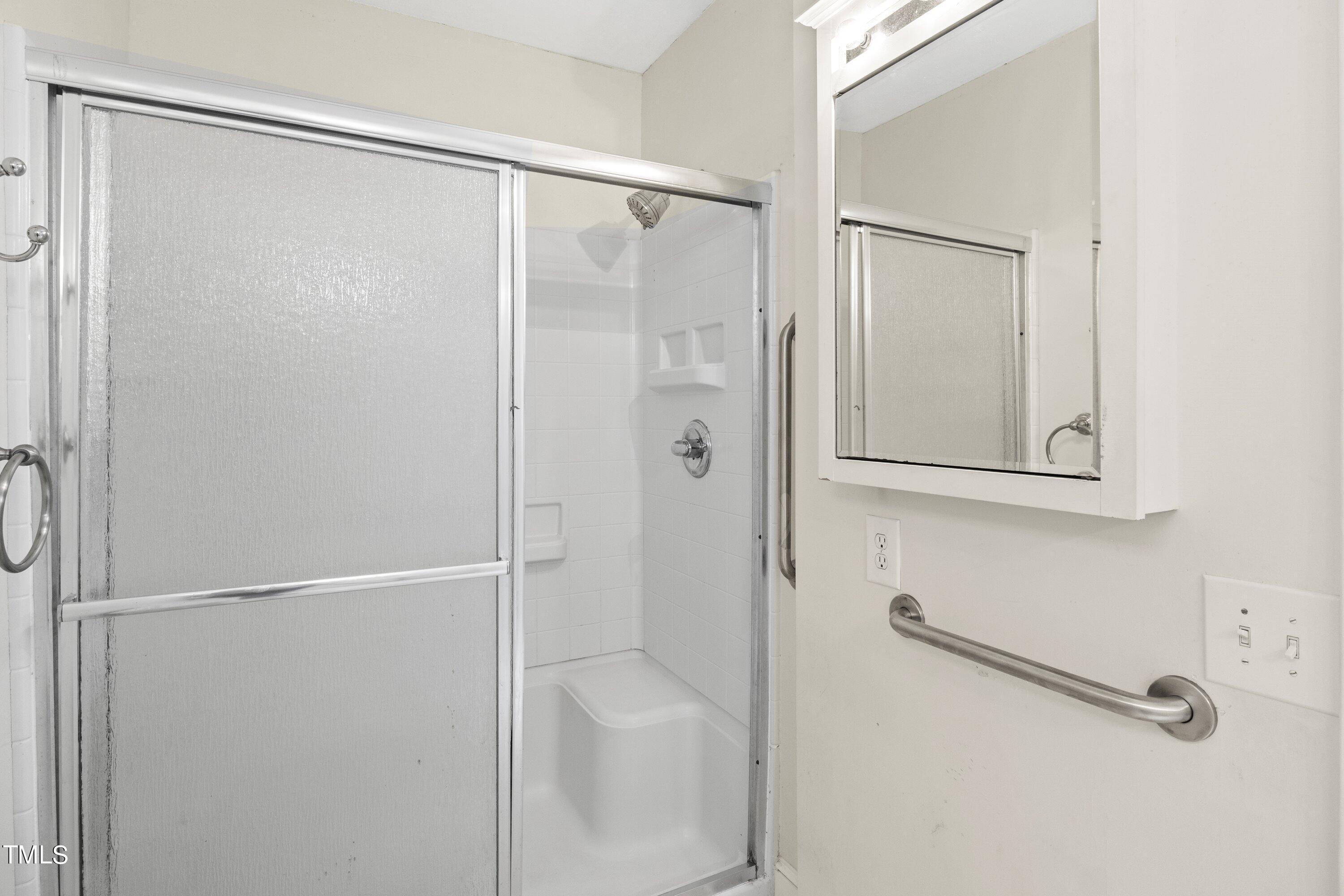 11 Partin Road Dunn, NC 28334 - Photo 24 of 46 a bathroom with a glass shower door
