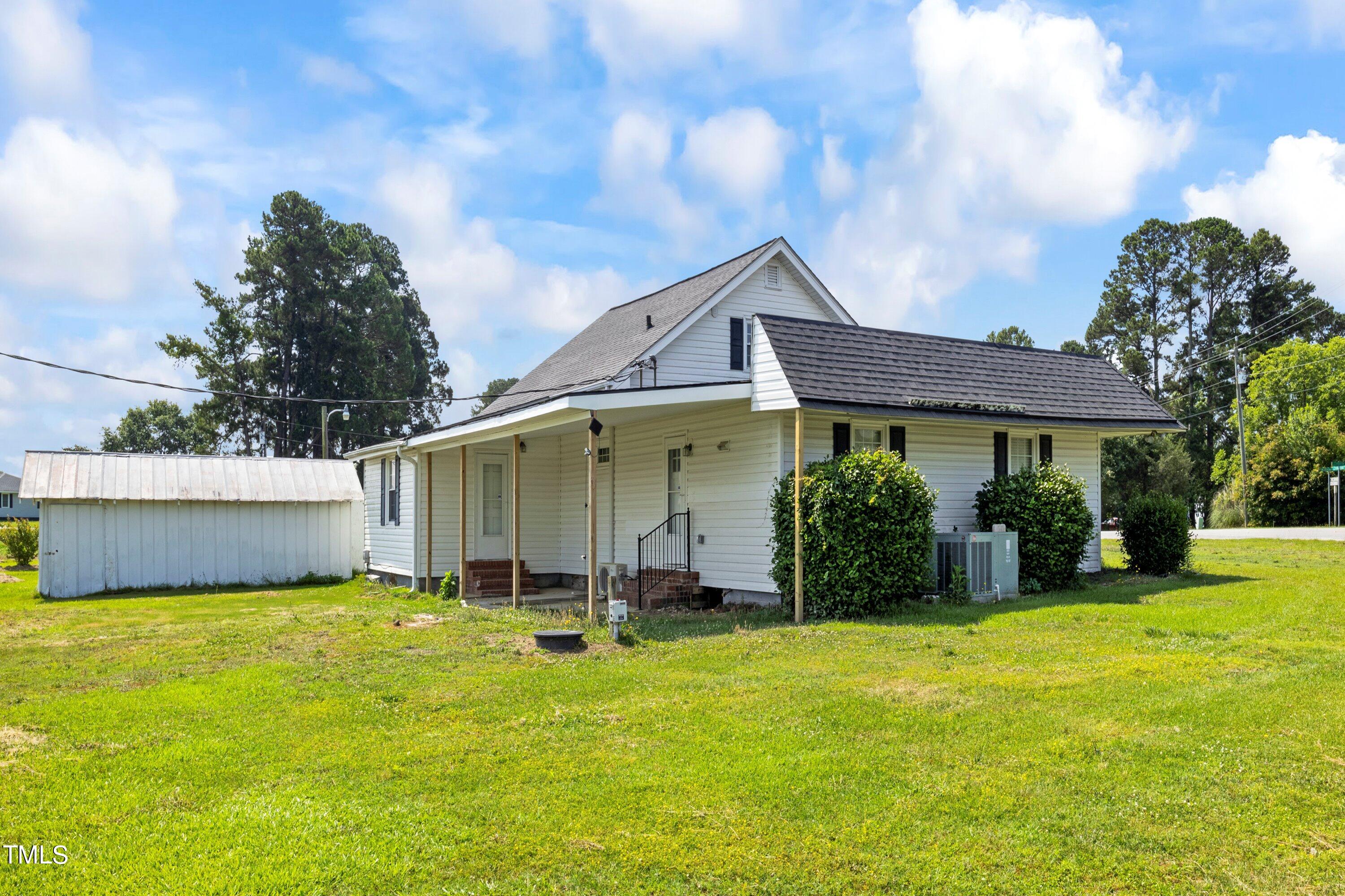 11 Partin Road Dunn, NC 28334 - Photo 46 of 46 a view of a white house with a big yard and potted plants
