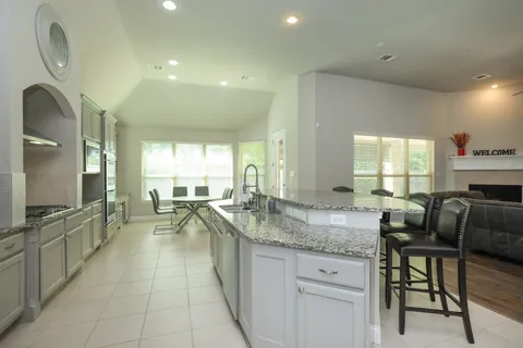 a kitchen with granite countertop lots of counter top space and dining table