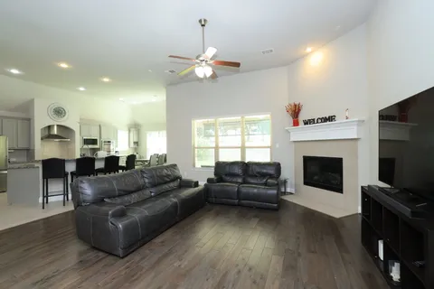 a living room with furniture a fireplace and a flat screen tv