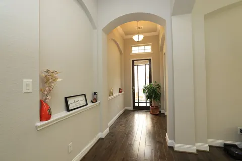 a view of a hallway view with wooden floor and staircase