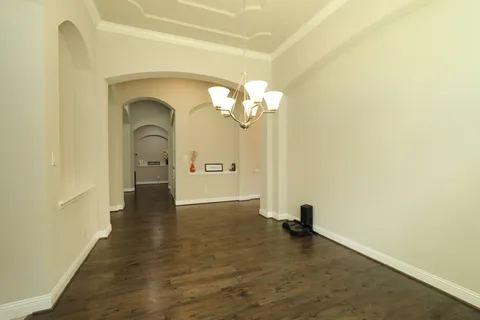 a view of a living room with a fireplace and wooden floor