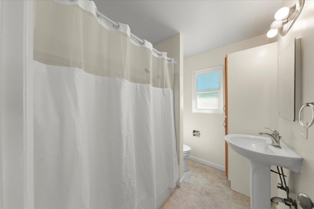 41 Ralston Drive Monterey, CA 93940 - Photo 27 of 31 a bathroom with a sink a mirror and a shower