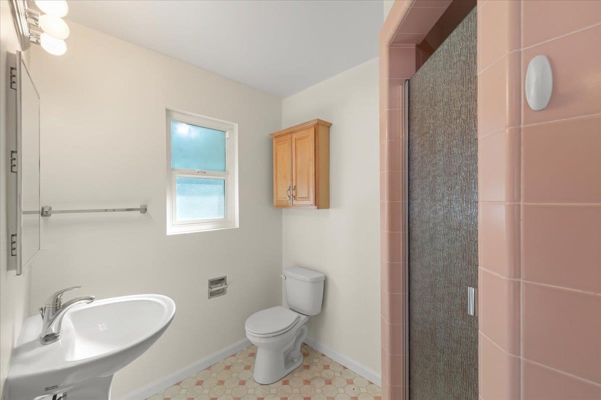 41 Ralston Drive Monterey, CA 93940 - Photo 29 of 31 a bathroom with a toilet a sink and mirror