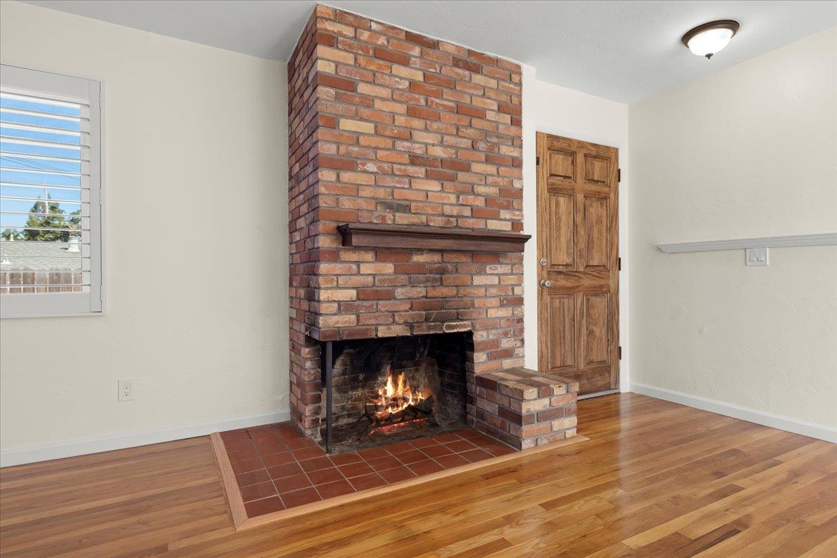 41 Ralston Drive Monterey, CA 93940 - Photo 6 of 31 an empty room with wooden floor fireplace and windows