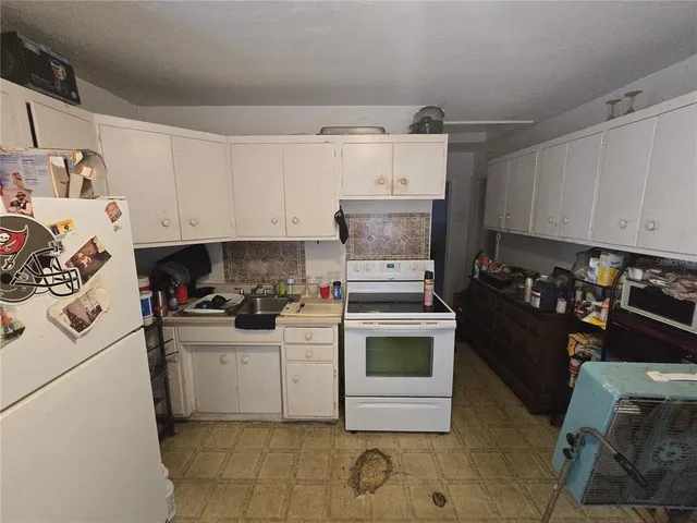 a kitchen with a sink cabinets and appliances
