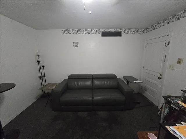 a couch sitting in a room next to a bathroom