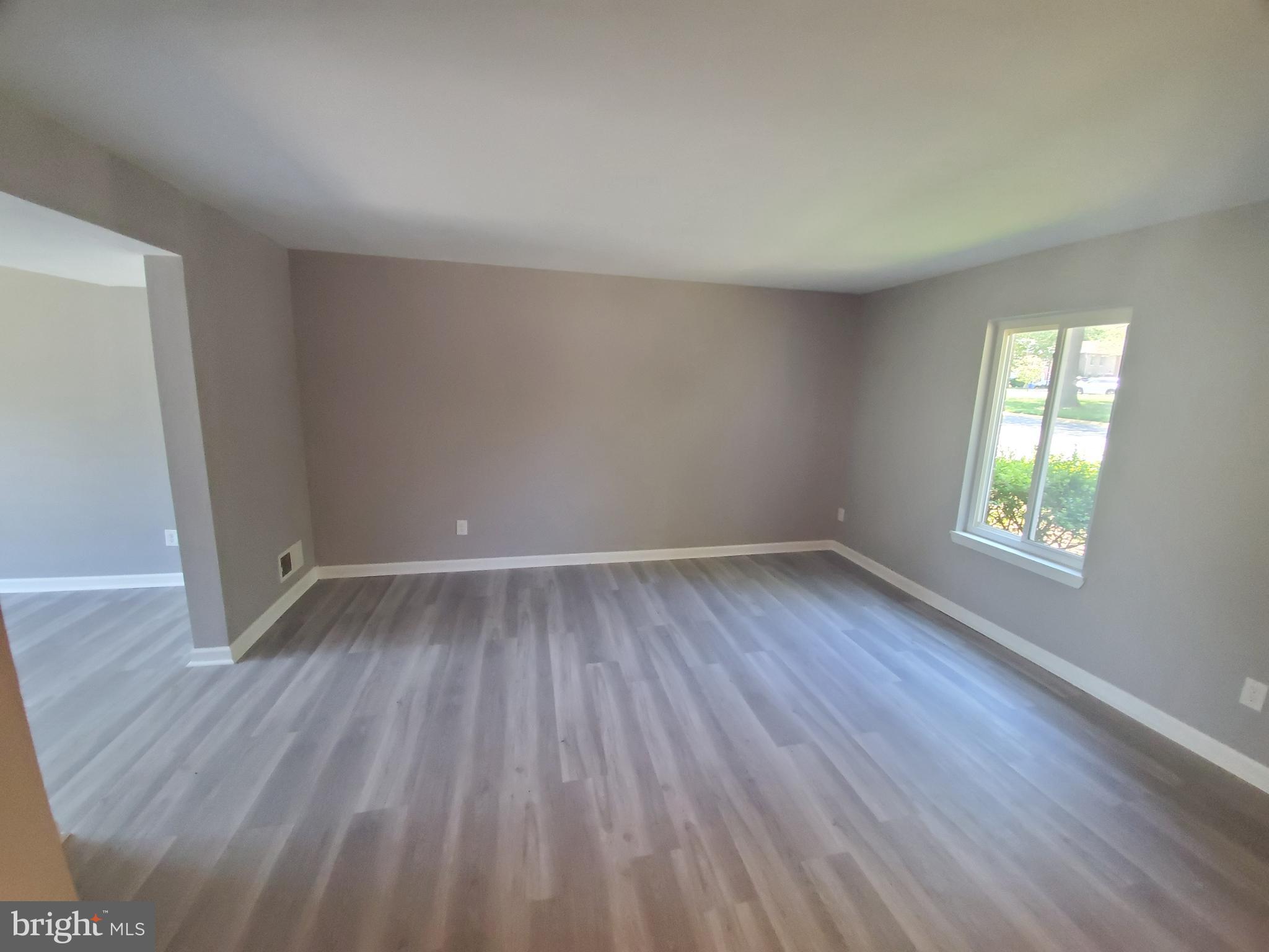19349 Keymar Way Montgomery Village, MD 20886 - Photo 3 of 13 an empty room with wooden floor and windows