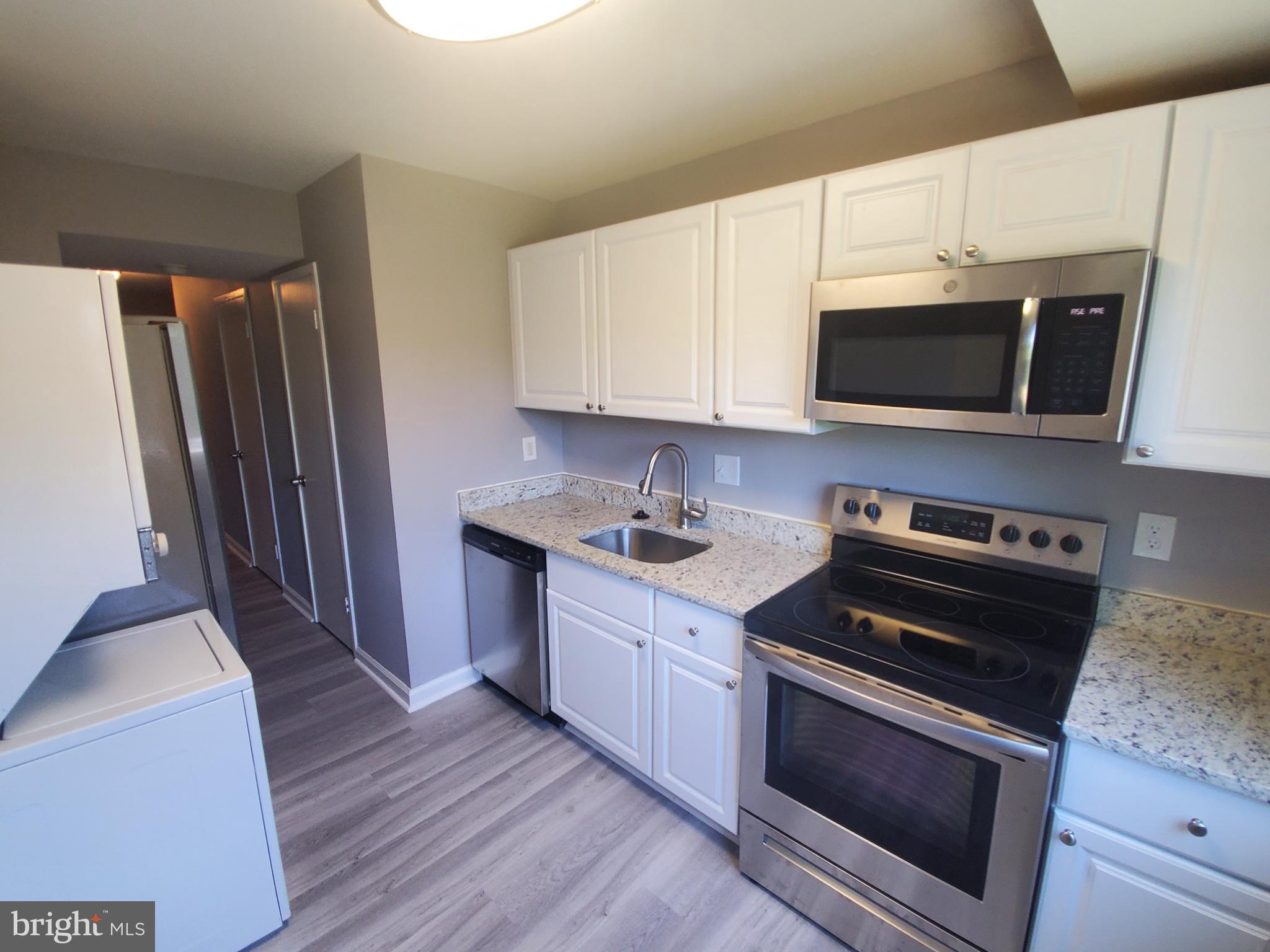 19349 Keymar Way Montgomery Village, MD 20886 - Photo 5 of 13 a kitchen with granite countertop a sink and steel appliances