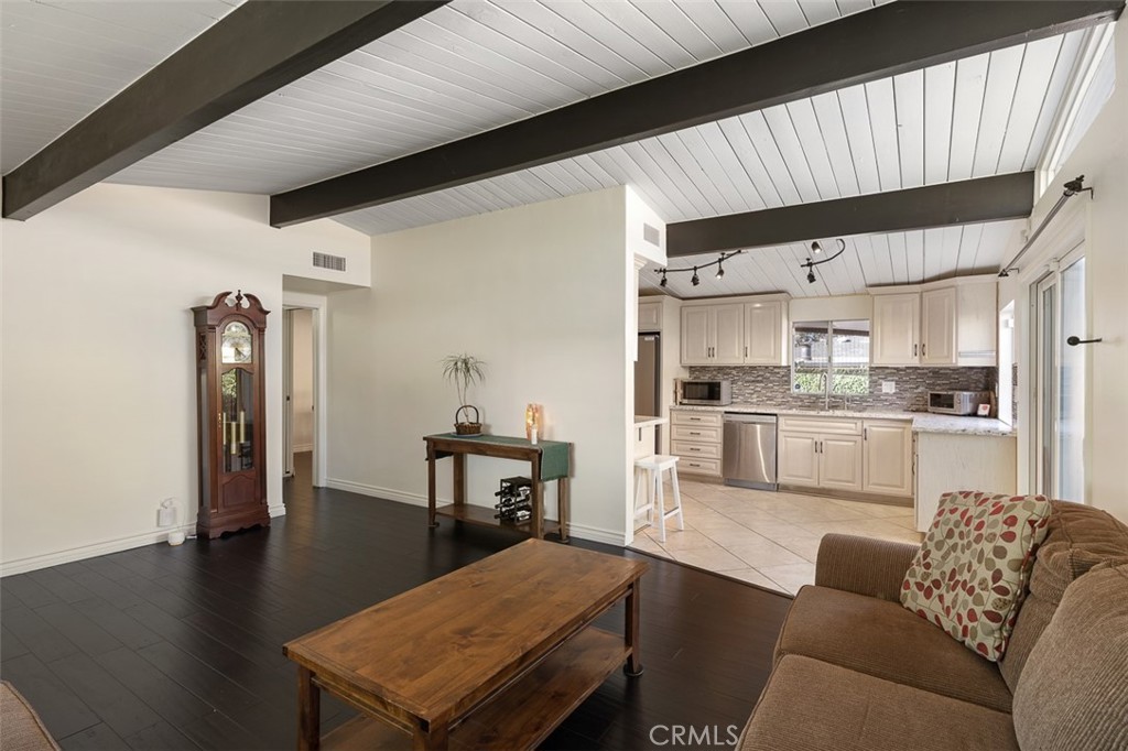 1391 North Fenimore Avenue Covina, CA 91722 - Photo 11 of 43 a living room with stainless steel appliances kitchen island granite countertop furniture and a wooden floor