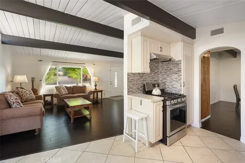 a kitchen with a stove and white cabinets