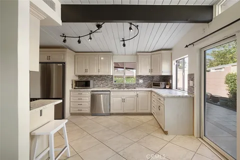 a kitchen with cabinets and wooden floor