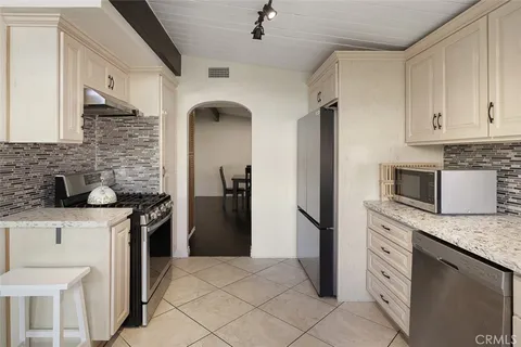 a kitchen with a sink stove and refrigerator