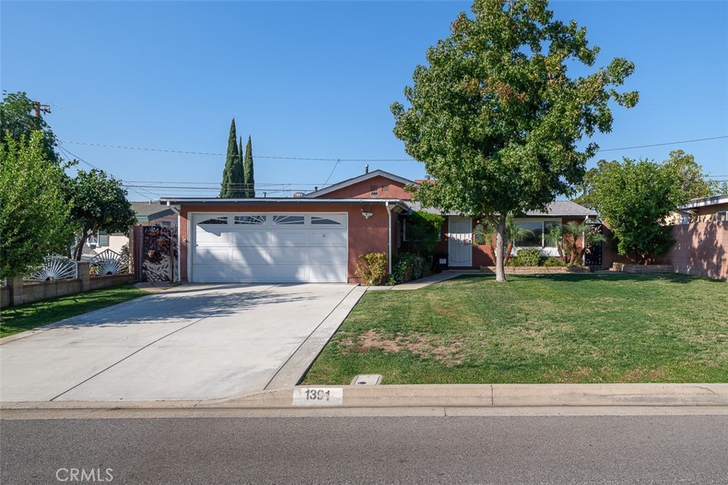 1391 North Fenimore Avenue Covina, CA 91722 - Photo 2 of 43 a front view of a house with a garden and trees