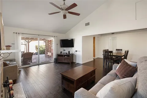 a living room with furniture and a flat screen tv with wooden floor