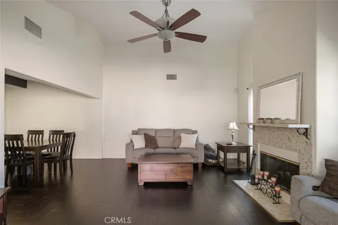 a living room with furniture and a fireplace with a dining table