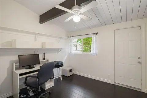 a view of workspace with wooden floor windows